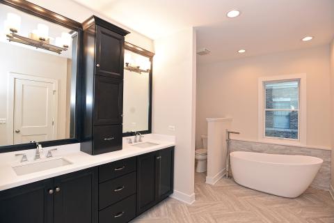 owners suite bathroom - freestanding tub and vanity top mounted cabinet