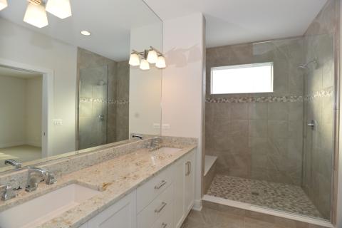 St. James - owners suite bathroom with pebble shower floor