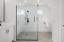 Custom bath with a roll in shower option featured in the Dover ranch home in Munhall Glen of Saint Charles